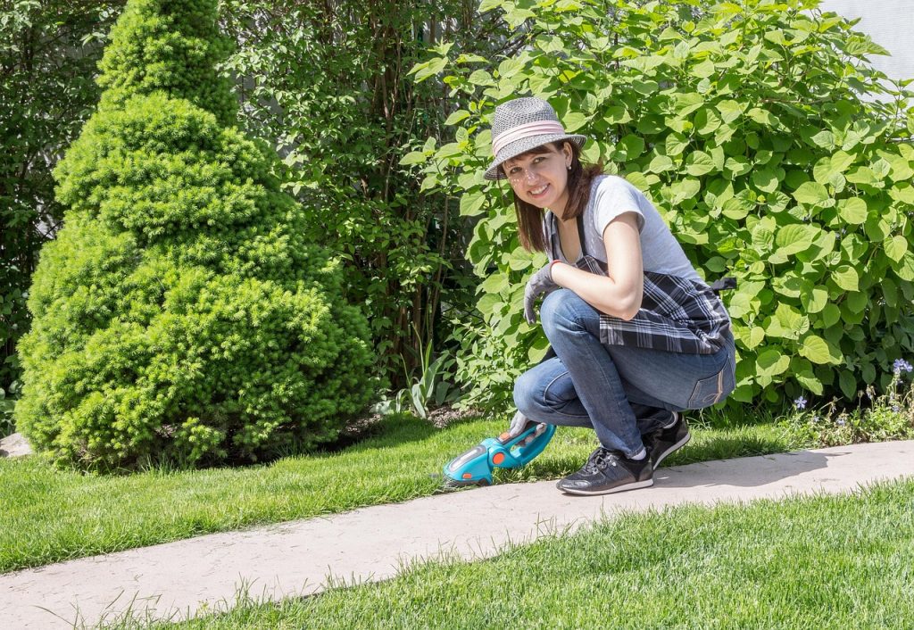 Woman with hat doing residential landscaping Ontario